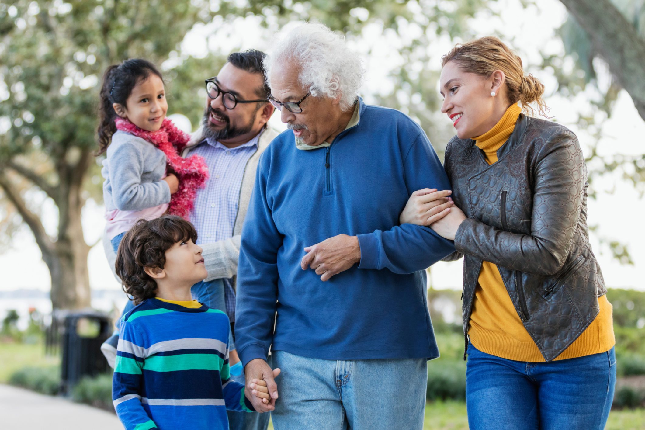 Multigenerational family enjoying a walk outdoors together.