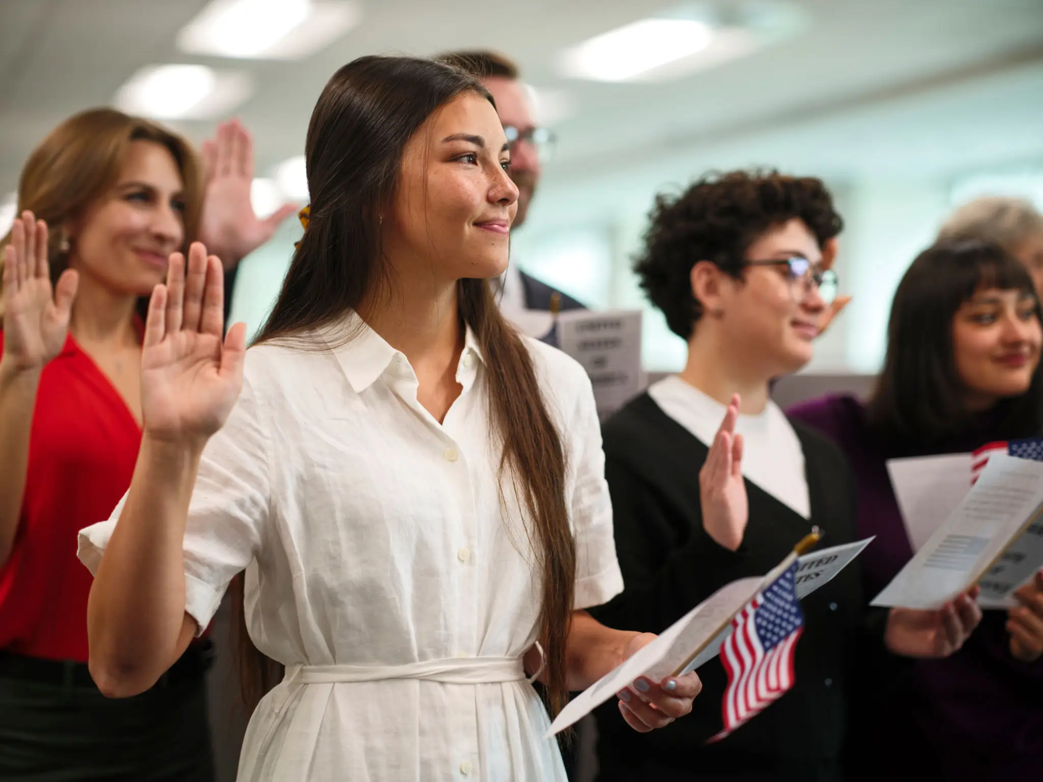 Young woman taking an oath in a naturalization ceremony.